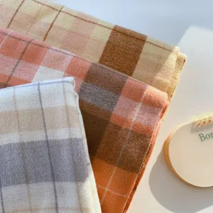 Detailed close-up of winter warm plaid imitation cashmere scarf fabric texture, cozy and soft.