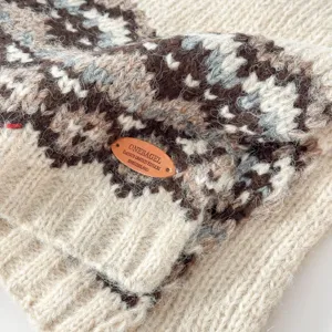 Close up of winter chunky knit Fair Isle jacquard scarf detail showing soft wool texture tag.