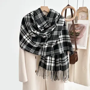 Classic black and white plaid scarf detail shot, showing soft textured fabric and fringe ends.