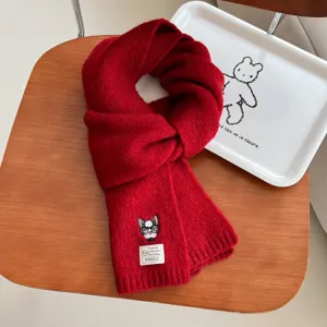 Details of the red knitted winter scarf with cute embroidered dog, warm wool blend neck wrap.