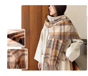 Cozy winter plaid scarf detail, showing soft cashmere-like fabric texture and fine fringe trim.