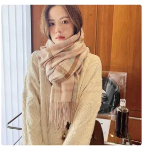 Detail view of women's thick plaid cashmere feel scarf, warm winter neckerchief styling.