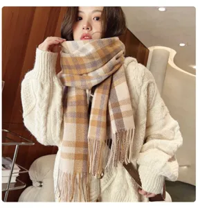 Detailed view of the stylish winter plaid scarf worn by a model, soft warm cashmere feel.