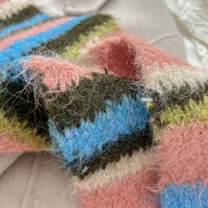 Cozy fuzzy striped knit scarf detail, soft mohair-like winter neck warmer for women.