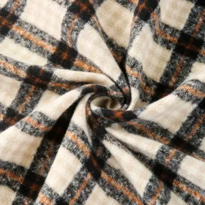 Close-up detail of a vintage retro plaid winter scarf showcasing soft warm fabric texture.