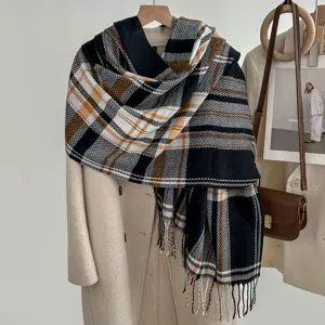 Detailed view of winter plaid fringe scarf draped on coat, cozy and stylish texture.