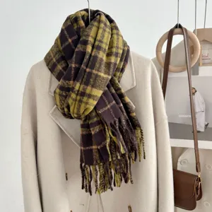 Cozy plaid tassel scarf detail view, warm loop yarn winter accessory in brown and green tones.