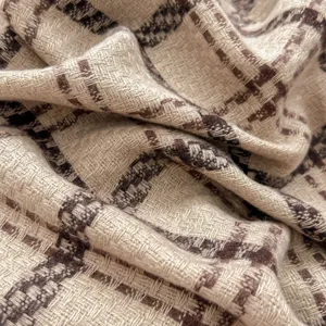 Close-up detail of retro plaid imitation cashmere scarf, showing soft winter fabric texture.