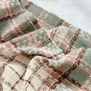 Cozy winter plaid scarf for women, soft knitted material with green and brown pattern, warm neck.