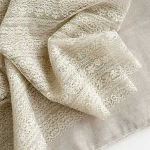 Exquisite beige lace scarf detail, soft and delicate fabric texture, elegant and lightweight.