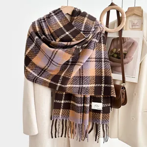 Cozy plaid blanket scarf detail shot, showing soft imitation cashmere texture and tassel trim.
