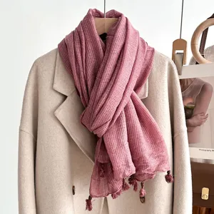 Textured linen cotton scarf detailed with fringe and wooden beads in dusty rose.