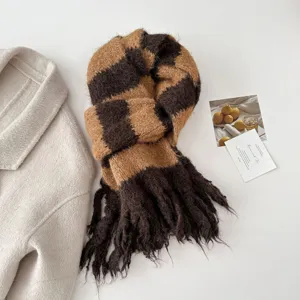 Detailed view of brown striped knitted fringe scarf, soft cashmere-feel winter neck warmer.