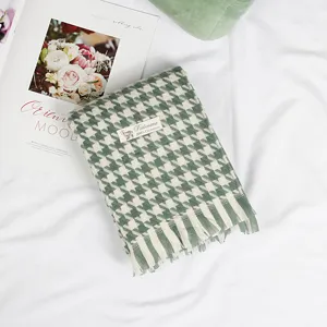 Green houndstooth scarf detail flat lay cozy autumn winter warm tassel wrap fashion accessory
