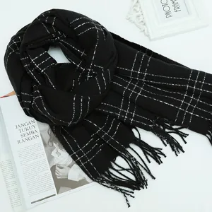 Black plaid winter scarf with white grid pattern and tassel fringe, cozy and warm apparel.