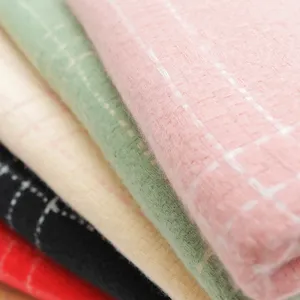Close-up detail of soft imitation cashmere plaid scarf showing delicate textured fabric.