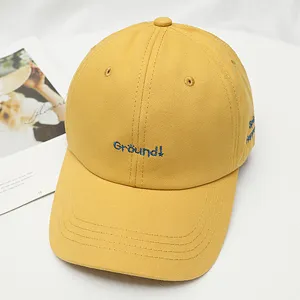Yellow cotton baseball cap for women, stylish embroidered letter design, casual sun protection.