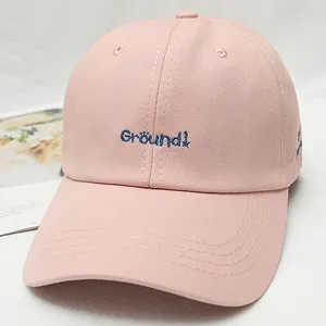 Pink cotton baseball cap with blue embroidered detail, classic curved brim and breathable eyelets.