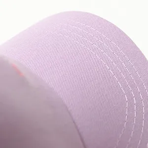 Close-up detail of light purple baseball cap featuring neat white stitching and fabric texture.