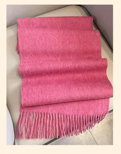 Pink winter tassel wool scarf detail view, thick soft warm knit shawl, cozy cold weather accessory.