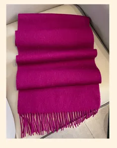 Detailed view of the solid color wool scarf, showing fine texture and soft fringe edge.