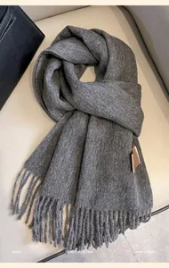 Cozy winter wool scarf in dark grey, featuring classic fringe design for ultimate warmth and style.