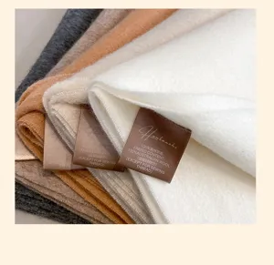 Detail shot of pure Australian wool winter scarf showing soft texture and clear label.