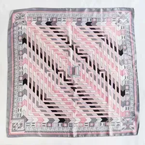 Detailed view of women geometric square silk scarf with elegant pink and grey labyrinth pattern.
