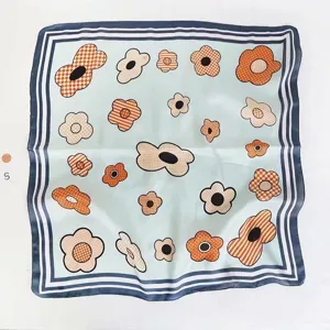 Retro floral print square scarf detail showing light blue fabric and colorful patterns.