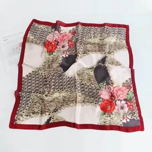 Classic floral silk scarf with chain print and red border, elegant square accessory.