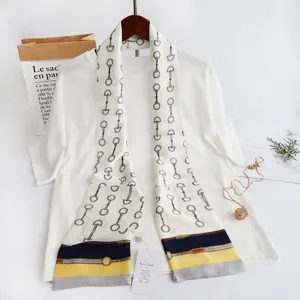 Women's narrow long silk scarf with classic equestrian horsebit print and chic color block.