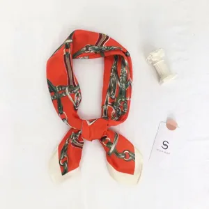 Elegant orange silk square scarf with vintage equestrian harness print, chic fashion neckerchief.