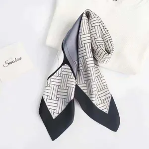 Detailed view of the black and white geometric printed silk square scarf, elegant and chic.
