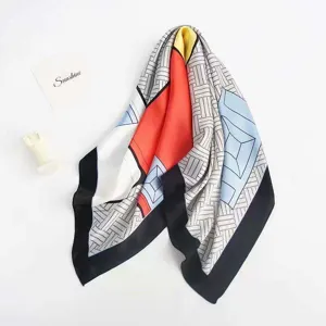 Geometric print silk feel square scarf detail view showing vibrant color block design and fabric.