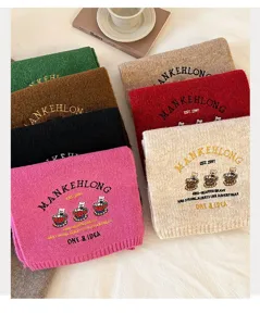 Detailed view of winter thick knitted wool scarves with cute bear embroidery and letters.