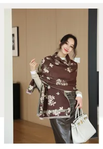 Detailed view of the stylish brown floral cashmere-feel scarf worn by model, perfect autumn style.