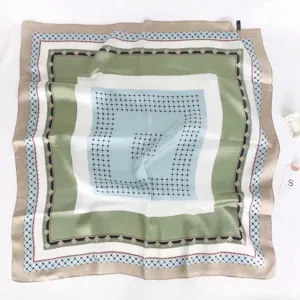 Elegant square silk scarf with chic geometric grid design, versatile fashion accessory.