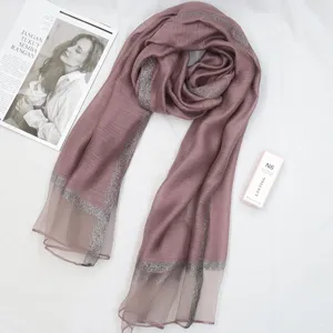 Elegant dusty pink long scarf with shimmering border, soft thin shawl for stylish wear.