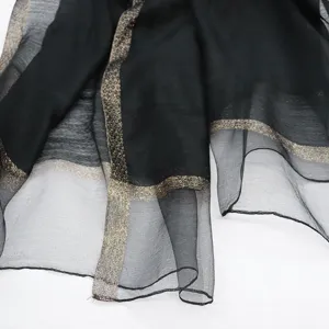 Black sheer silk cotton scarf with shimmering gold metallic border, lightweight shawl wrap.