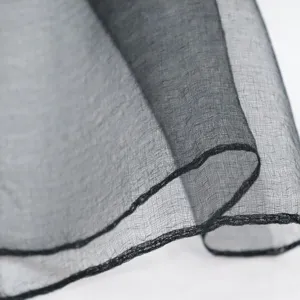 Detailed view of a lightweight black sheer silk cotton scarf showing fine texture.