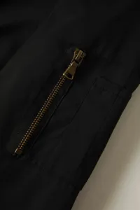 Close-up detail of the sleeve, zipper, and pocket on a mens casual bomber jacket.