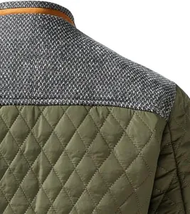 Men's patchwork quilted jacket detail showing textured grey yoke and olive green quilted body.