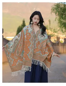Detailed view of the bohemian paisley patterned cashmere-feel shawl with elegant tassel hem.