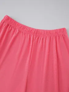 Pink pajama pants detail featuring elastic waistband and soft knit fabric texture.