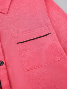 Close up detail of women sleepwear cardigan pink fabric chest pocket black piping style view