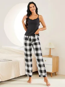 Detail shot of women's black camisole and black white plaid pajama pants two piece sleepwear