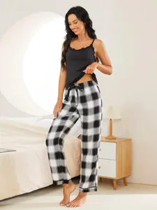 Women's two-piece plaid pajama set with black camisole and comfy long pants for sleepwear.