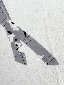 Grey patterned fabric belt tie detail shot for women sleepwear and loungewear sets.