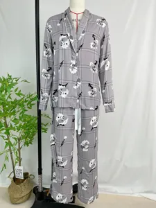 Detail view of women's grey plaid long sleeve pajama set with floral print and tie waist.