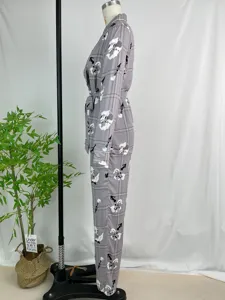 Grey plaid long sleeve pajama set detail view showing floral pattern, belt and side profile.